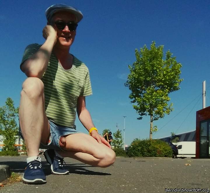 a bit of boxer underwear and much of balls penis and face outdoor in short jeans
