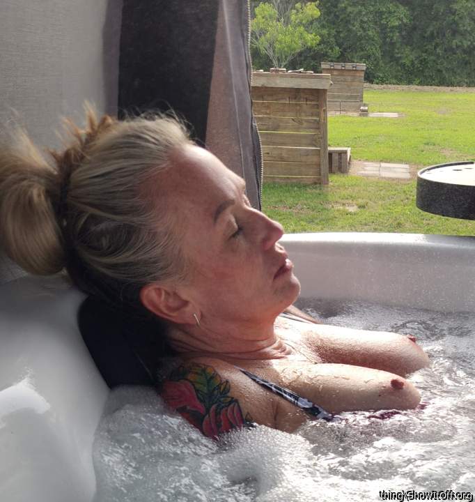 Wife's titties in the hot tub