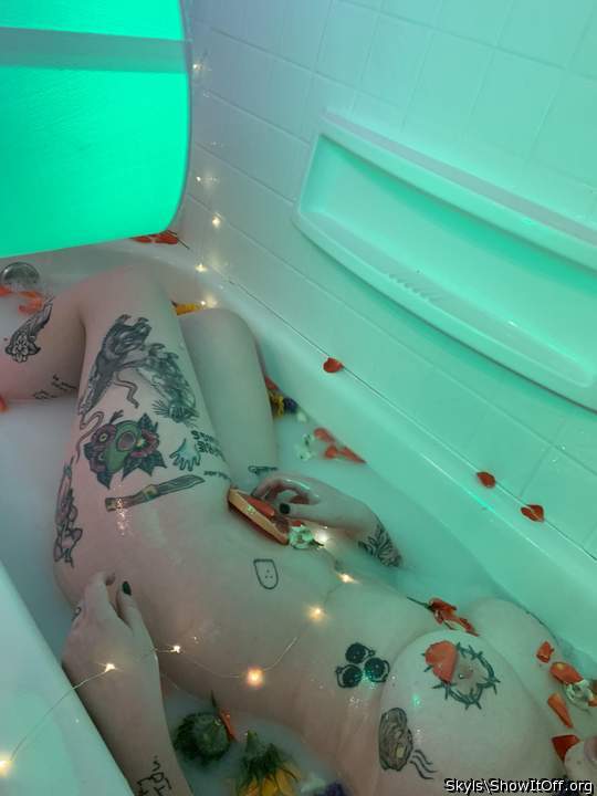 me and my tattoos in a milk bath with flowers