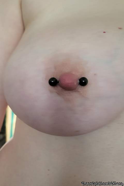 The piercing makes a good contrast to the pale nipple
