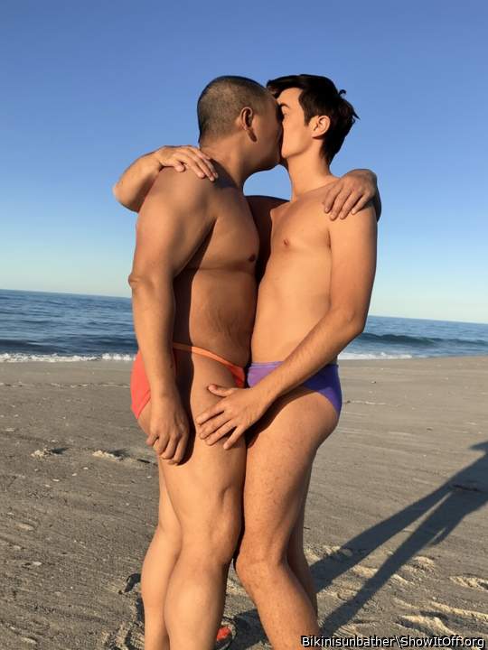 Kissing at the beach in our bikinis