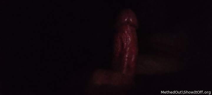 Shining veiny cock in darkness